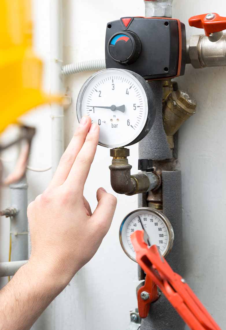 Technician checking pressure meters Technician checking pressure meters